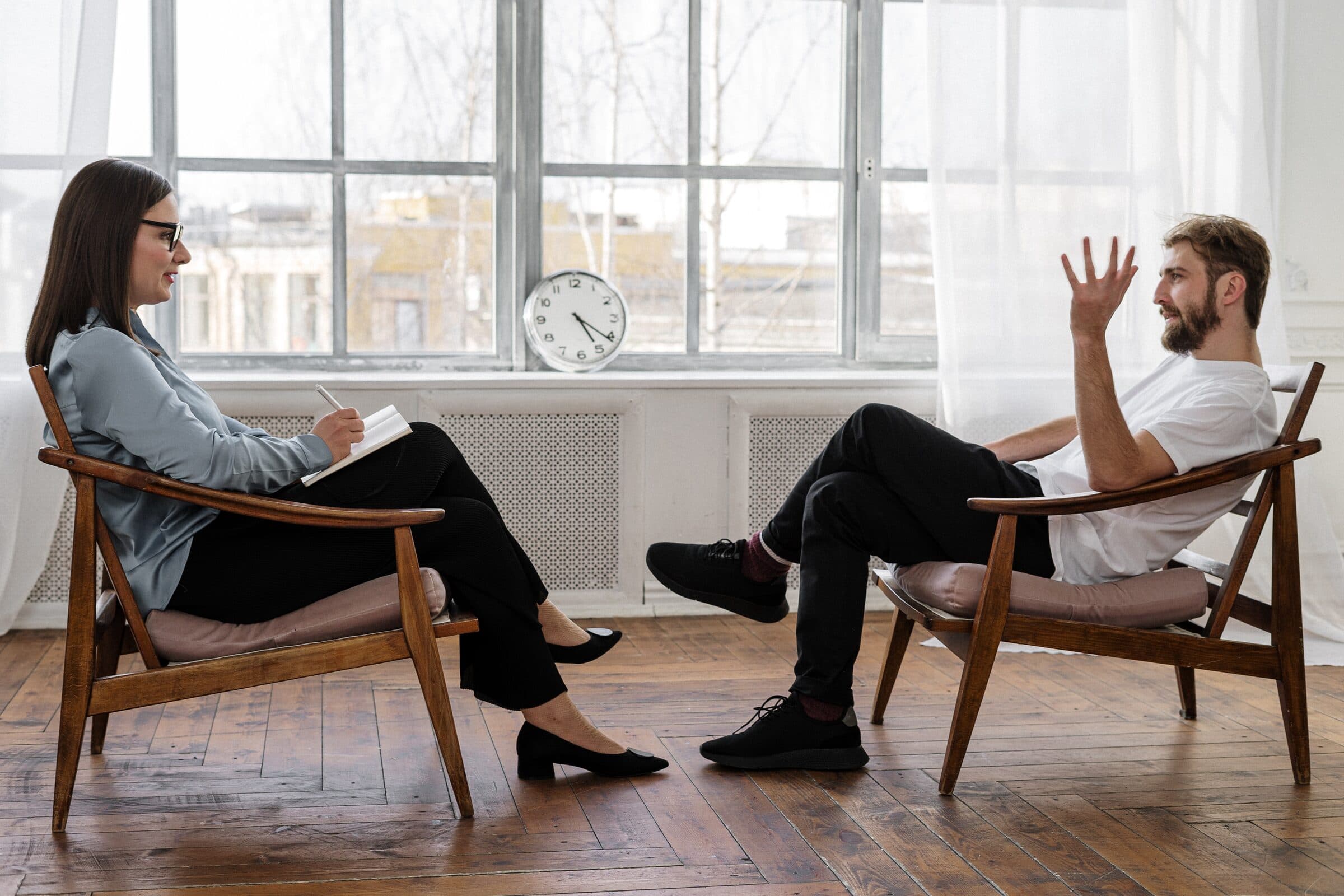 A provider and client in a warm, relaxed therapy session